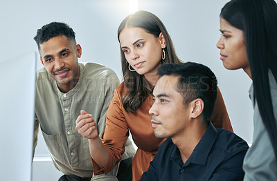 Buy stock photo Shot of a diverse group of businesspeople standing together in the office and using a computer