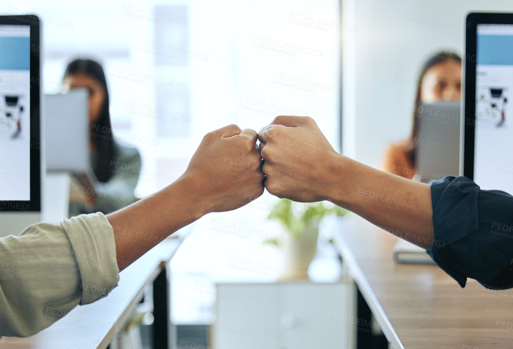Buy stock photo Computer, colleagues with fist bump and at their desk in coworking a office. Team building or teamwork, collaboration or partnership and coworkers with a handshake together at their workplace