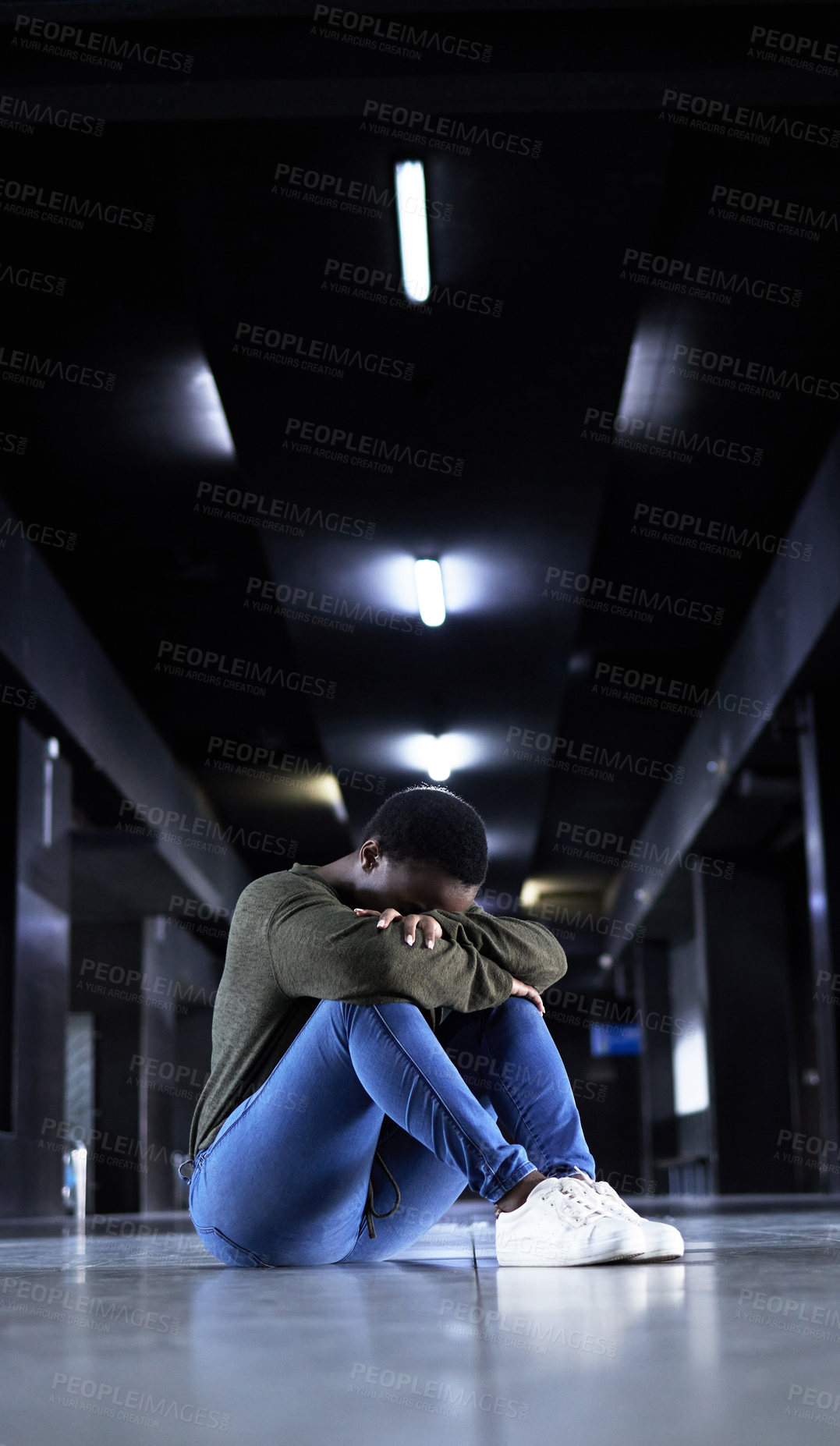 Buy stock photo Woman, depression and sad on floor at train station for bad memory, ptsd or lonely on travel in night. African girl, person and cry at metro terminal with anxiety, lost or stress for future in subway