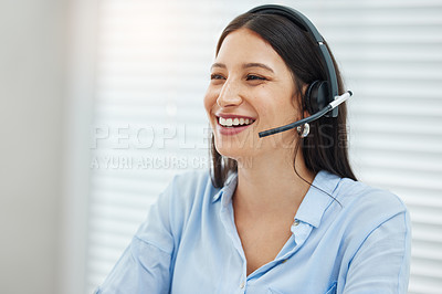 Buy stock photo Shot of an attractive young saleswoman sitting alone in her office and wearing a headset