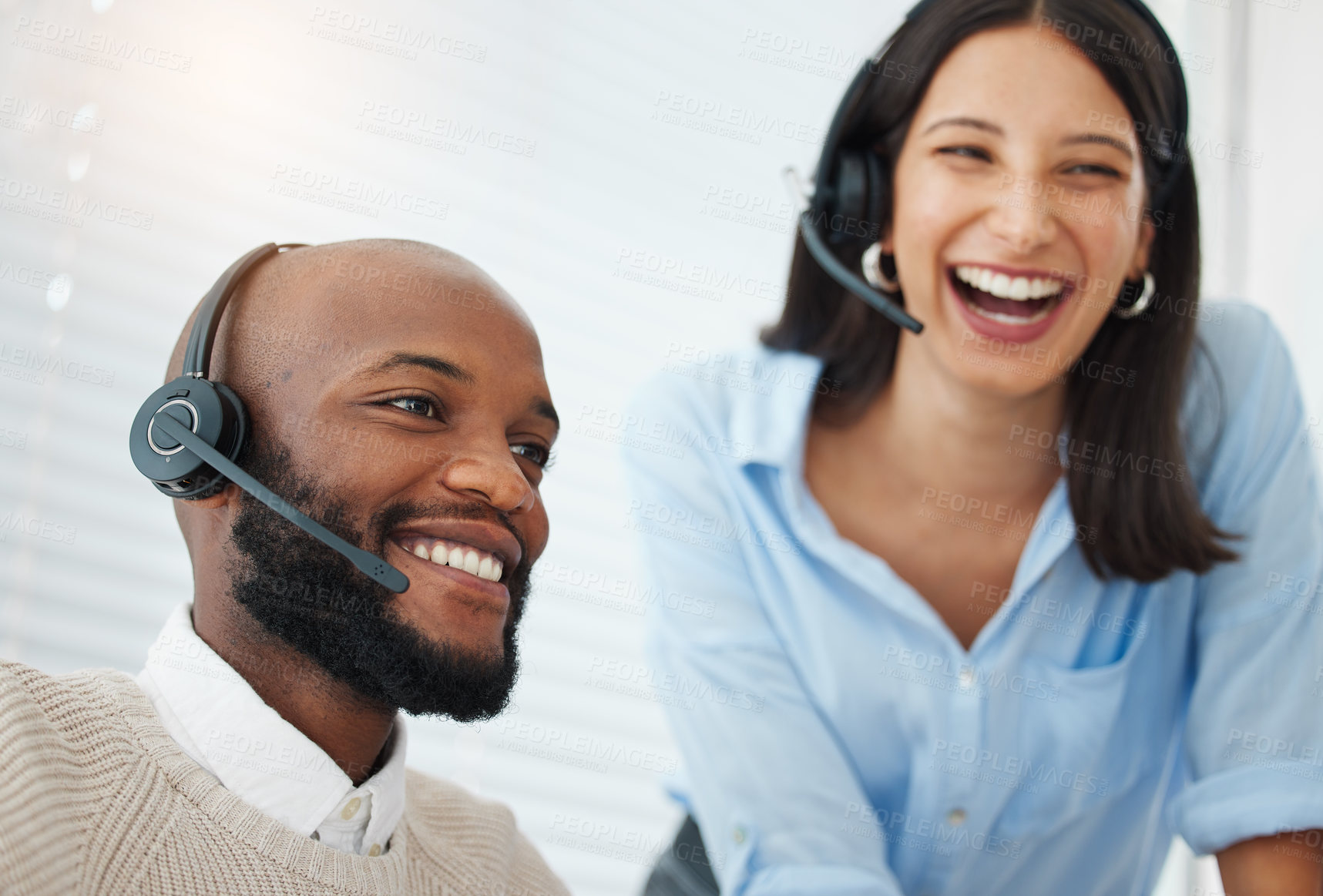 Buy stock photo Shot of a handsome young salesman sitting in the office and wearing a headset while getting help from his manager