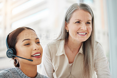 Buy stock photo Shot of an attractive young call centre agent sitting in the office and getting help from her manager