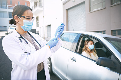 Buy stock photo Shot of a masked young doctor giving a patient an injection at a Covid-19 drive through testing centre