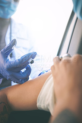 Buy stock photo Shot of a masked woman receiving an injection at a Covid-19 drive through testing centre