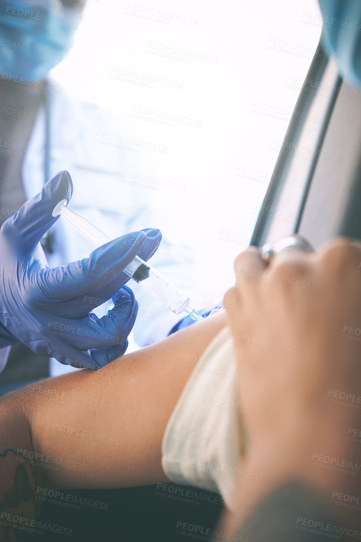 Buy stock photo Shot of a masked woman receiving an injection at a Covid-19 drive through testing centre