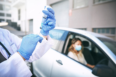 Buy stock photo Shot of a doctor giving a patient an injection at a Covid-19 drive through testing centre