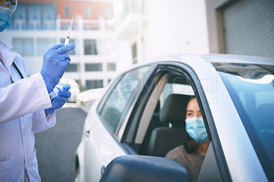 Buy stock photo Shot of a masked young woman receiving an injection at a Covid-19 drive through testing centre