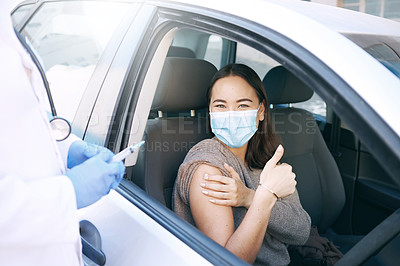 Buy stock photo Shot of a masked young woman receiving an injection at a Covid-19 drive through testing centre