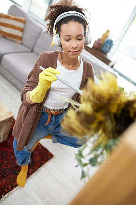 Buy stock photo Home, duster and woman with headphones, cleaning furniture surface and remove bacteria. Person, housekeeping and girl with headset, equipment and routine with podcast, service and listening to music