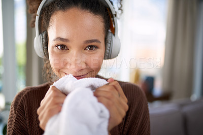 Buy stock photo Woman, home and laundry smell with headphones for music, comfort and portrait with housekeeping. Relax in living room, fresh scent and clean clothes with listening to radio or podcast in apartment