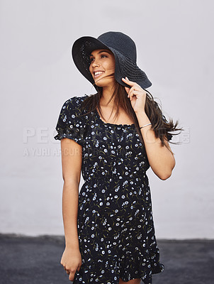 Buy stock photo Shot of an attractive young woman wearing a sunhat posing outdoors