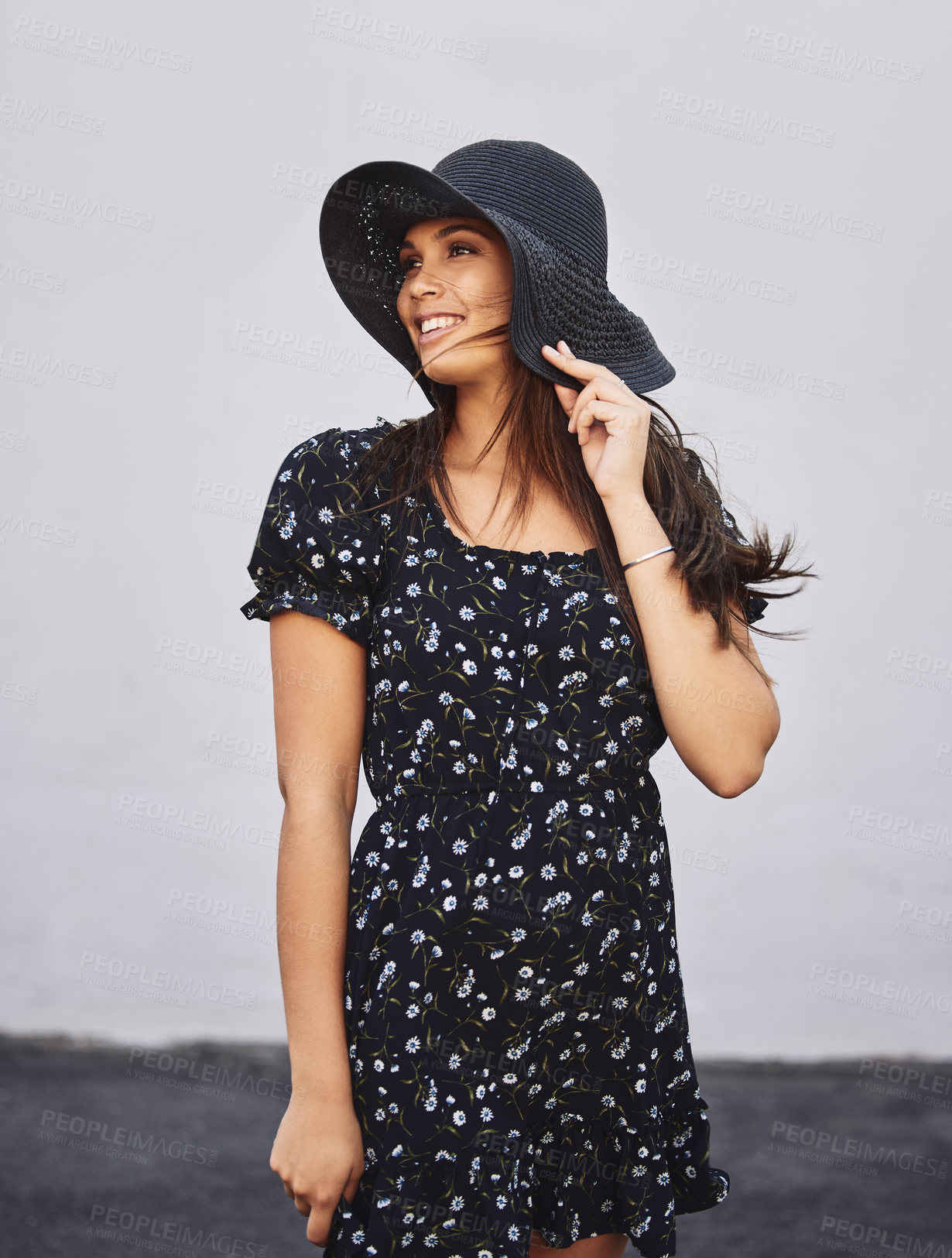 Buy stock photo Shot of an attractive young woman wearing a sunhat posing outdoors