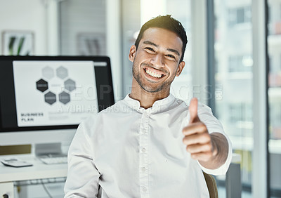 Buy stock photo Shot of a businessman showing thumbs up while sitting in a modern office
