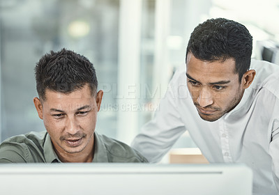 Buy stock photo Shot of two businessmen looking at something on a computer