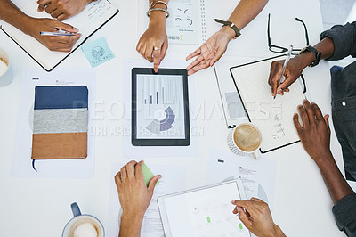 Buy stock photo Shot of anonymous colleagues using digital tablets during a business meeting