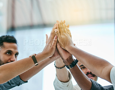 Buy stock photo Shot of a group of coworkers high fiving each other