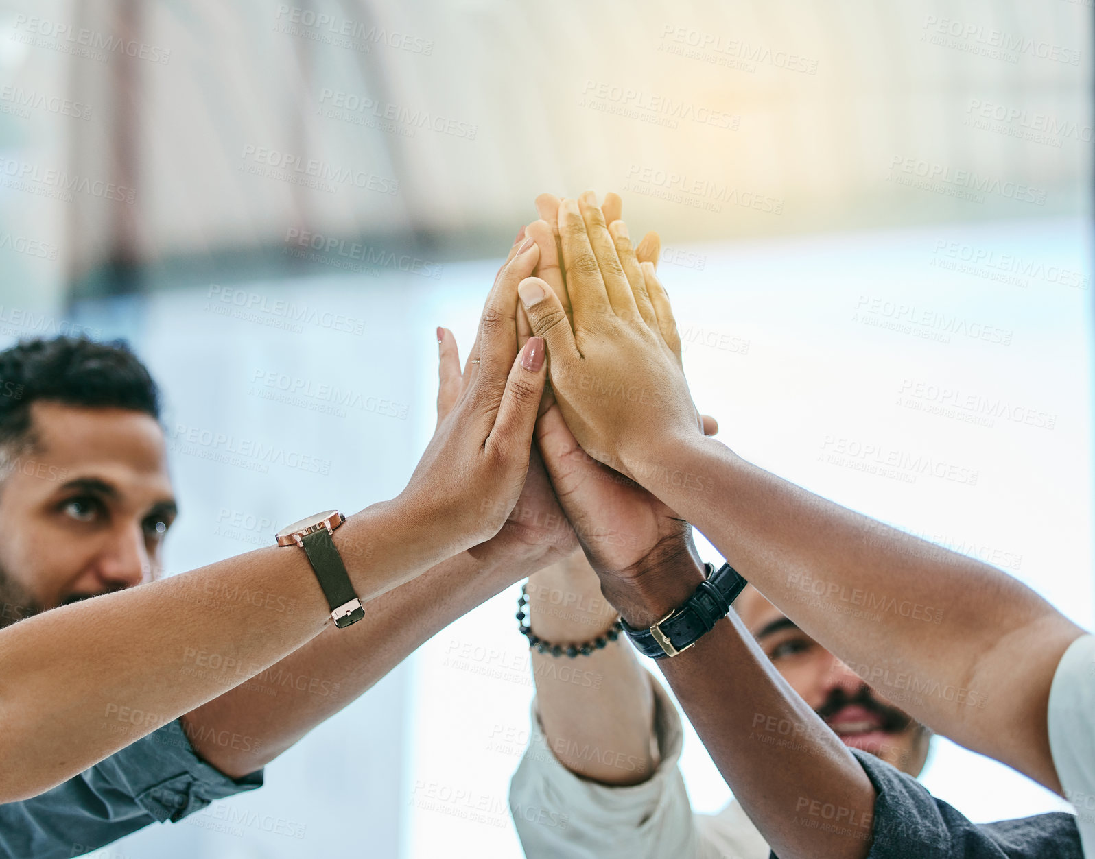 Buy stock photo Shot of a group of coworkers high fiving each other