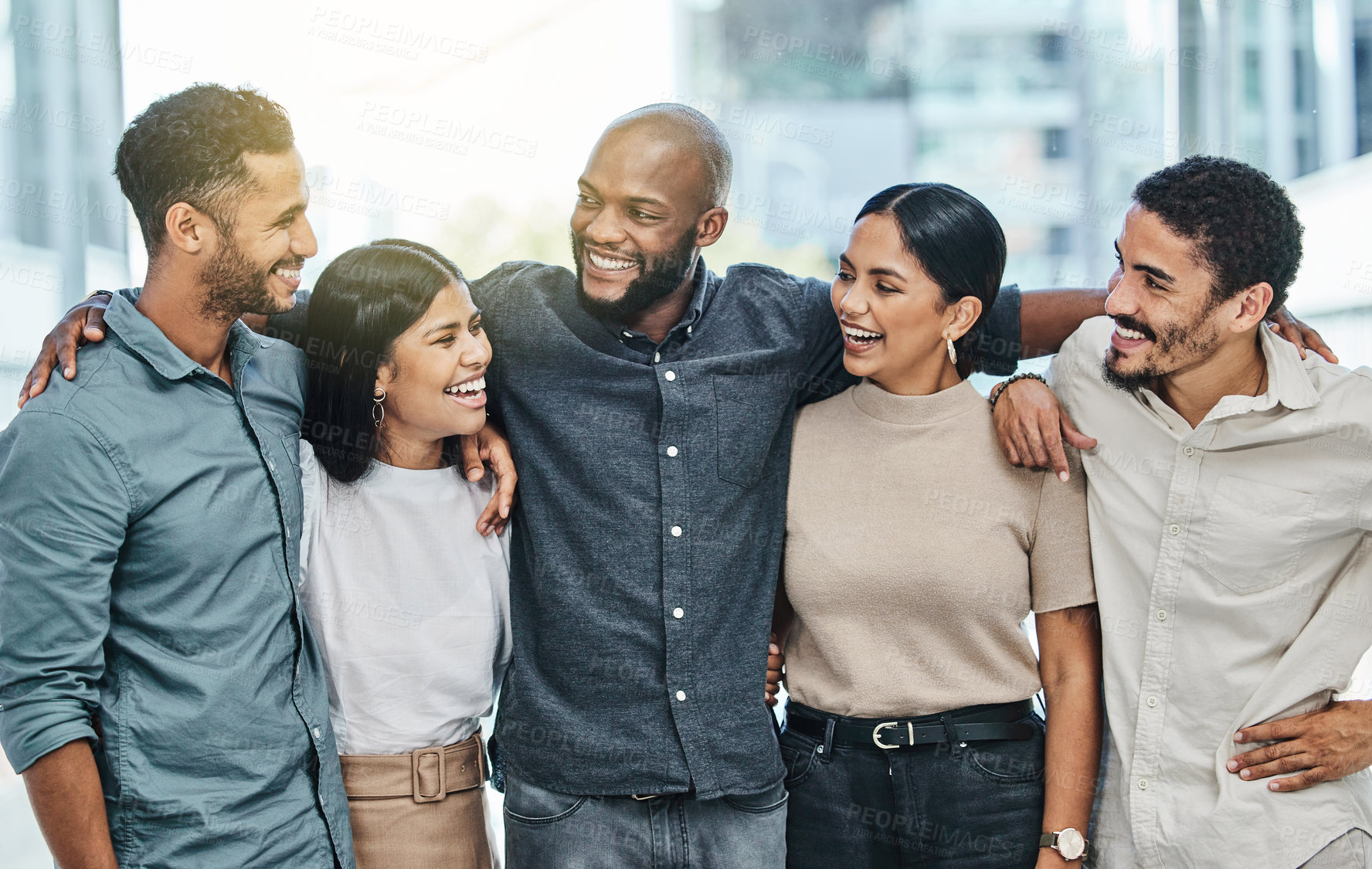 Buy stock photo Diversity, happy colleagues and in their office together at work with a lens flare. Teamwork or collaboration, funny or happiness and coworkers smiling or laughing at their modern workplace.