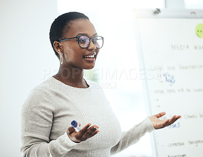 Buy stock photo Shot of a young woman giving a presentation in a modern office