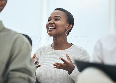 Buy stock photo Shot of a young woman sharing her opinion at a meeting in a modern office