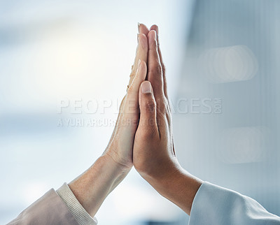 Buy stock photo Shot of two business colleagues high fiving each other