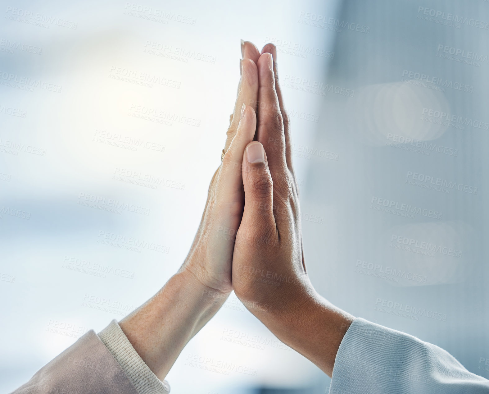 Buy stock photo Shot of two business colleagues high fiving each other