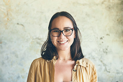 Buy stock photo Portrait of a confident young woman standing against a wall