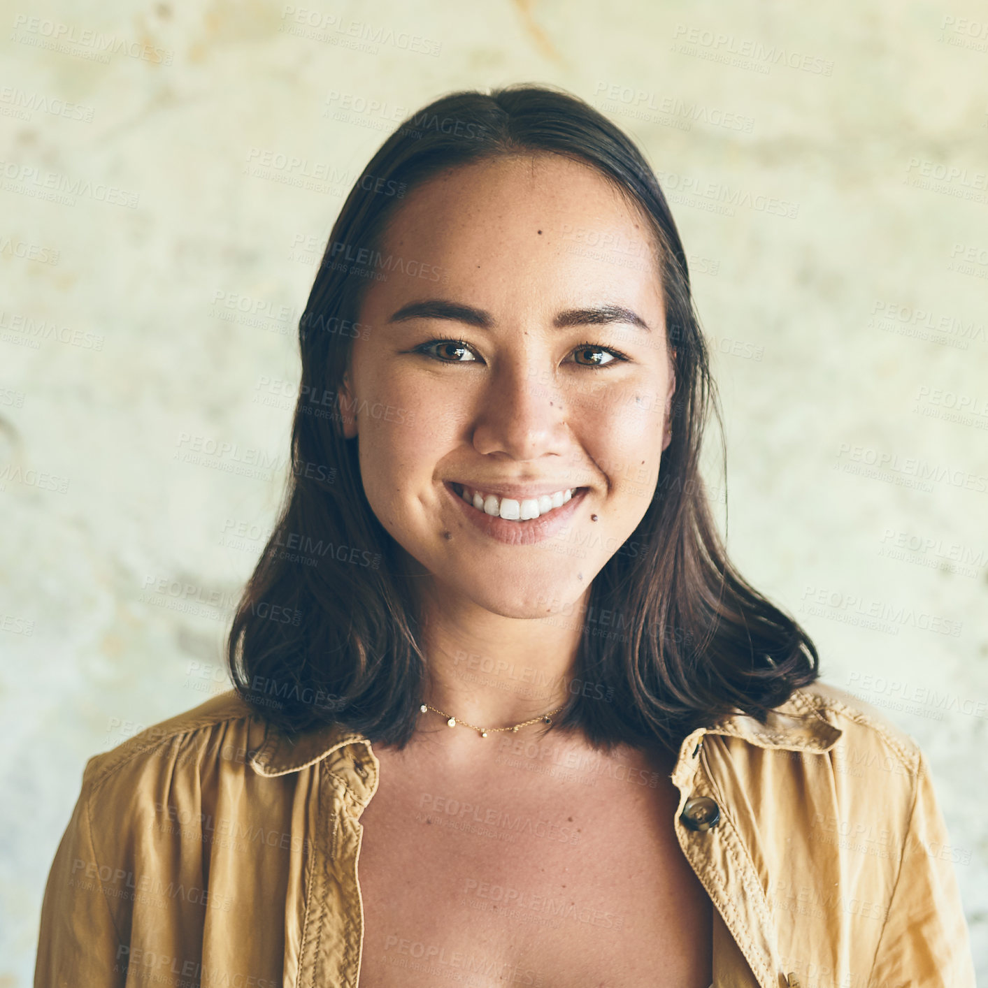 Buy stock photo Portrait of a confident young woman standing against a wall