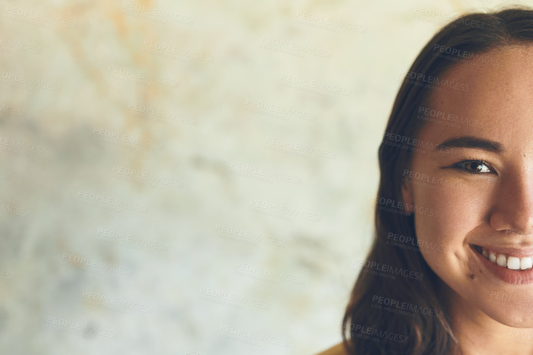 Buy stock photo Portrait of a confident young woman standing against a wall