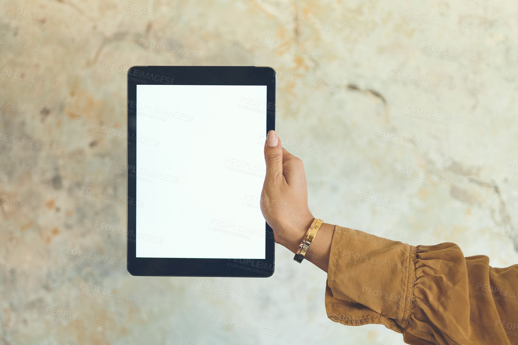 Buy stock photo Closeup shot of an unrecognisable woman holding a digital tablet with a blank screen against a wall