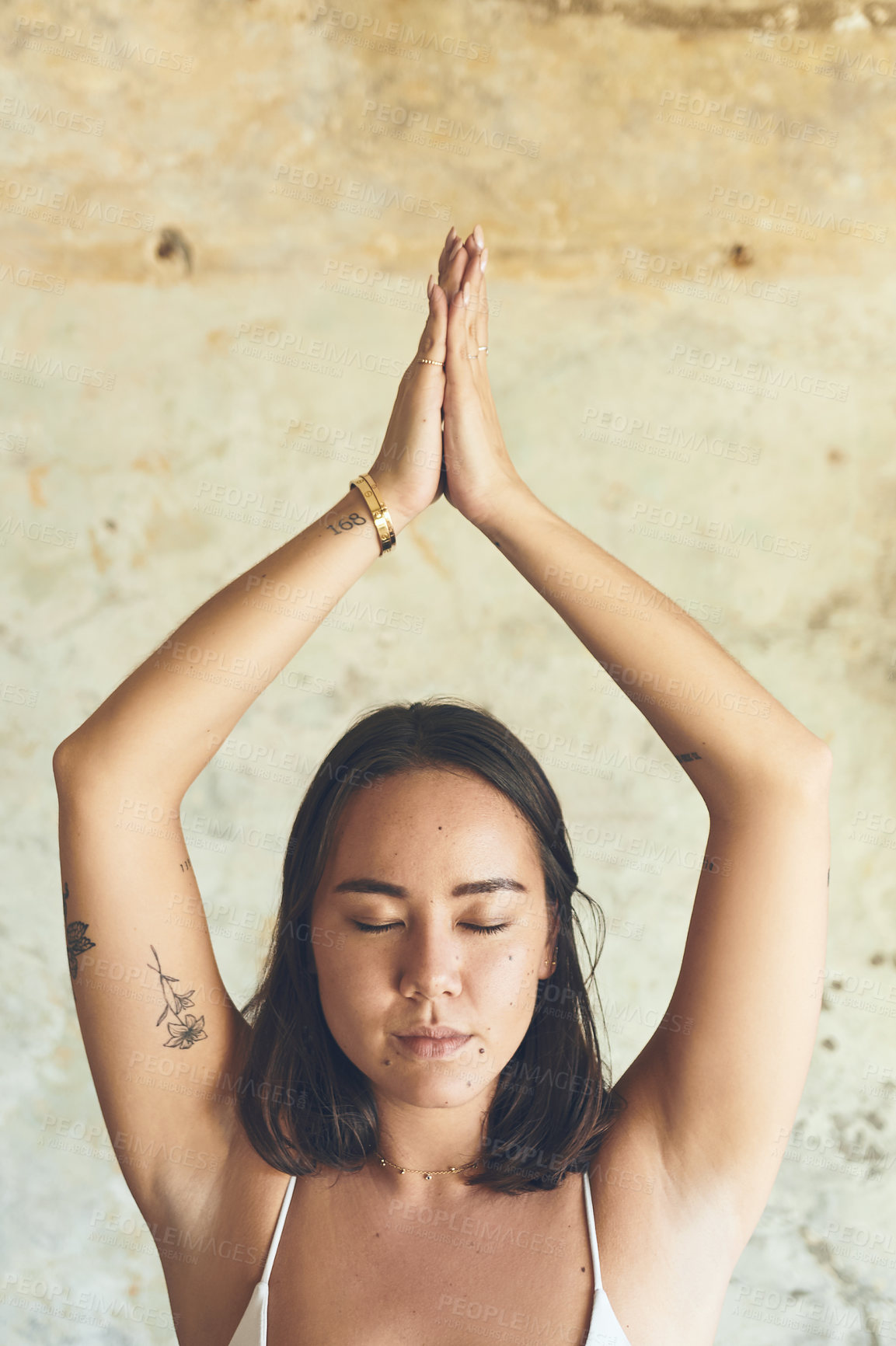 Buy stock photo Shot of a young woman meditating at home