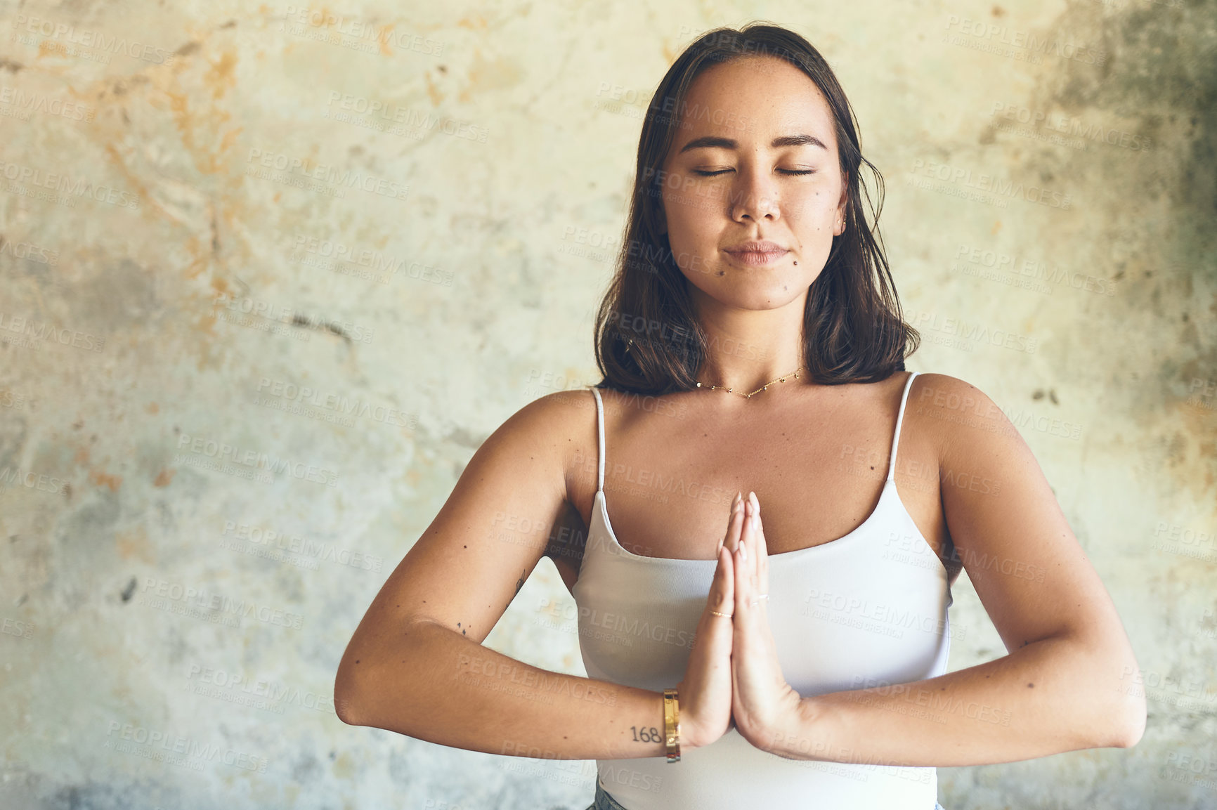 Buy stock photo Shot of a young woman meditating at home