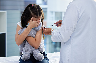 Buy stock photo Shot of a scared little girl getting a vaccination in a hospital