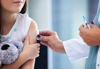 Buy stock photo Shot of a little girl getting a vaccination in a hospital