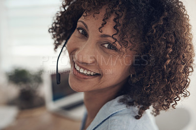 Buy stock photo Shot of an attractive young sitting alone at home and wearing headsets