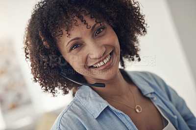 Buy stock photo Shot of an attractive young sitting alone at home and wearing headsets