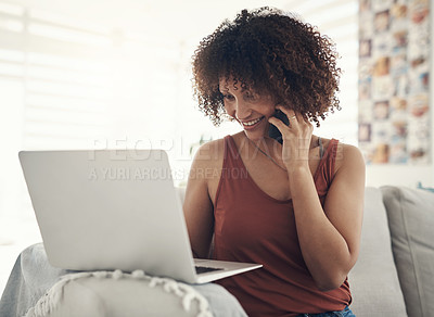 Buy stock photo Shot of an attractive young woman sitting on her sofa at home and using technology