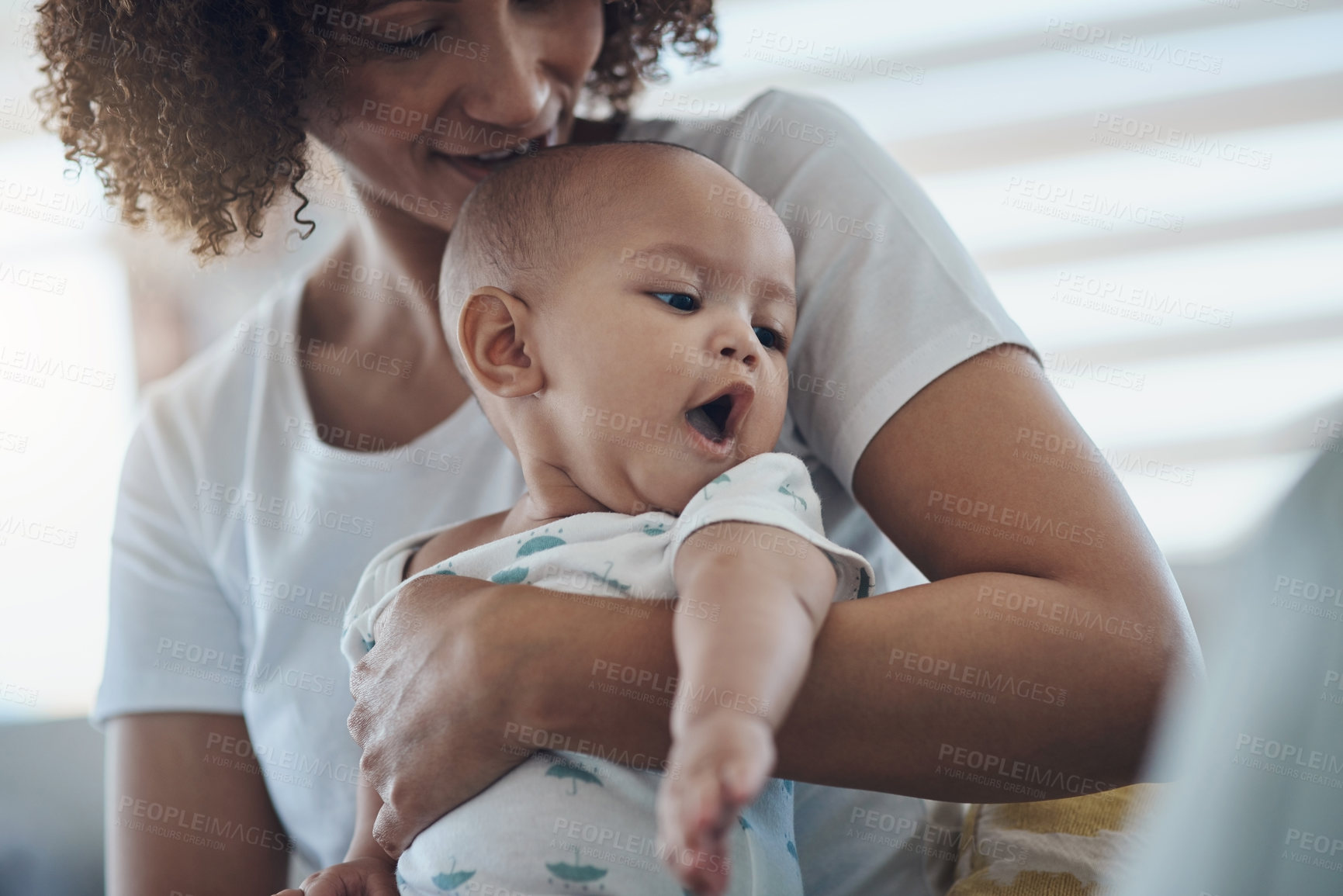 Buy stock photo Shot of a young woman relaxing with her adorable baby girl on the sofa at home