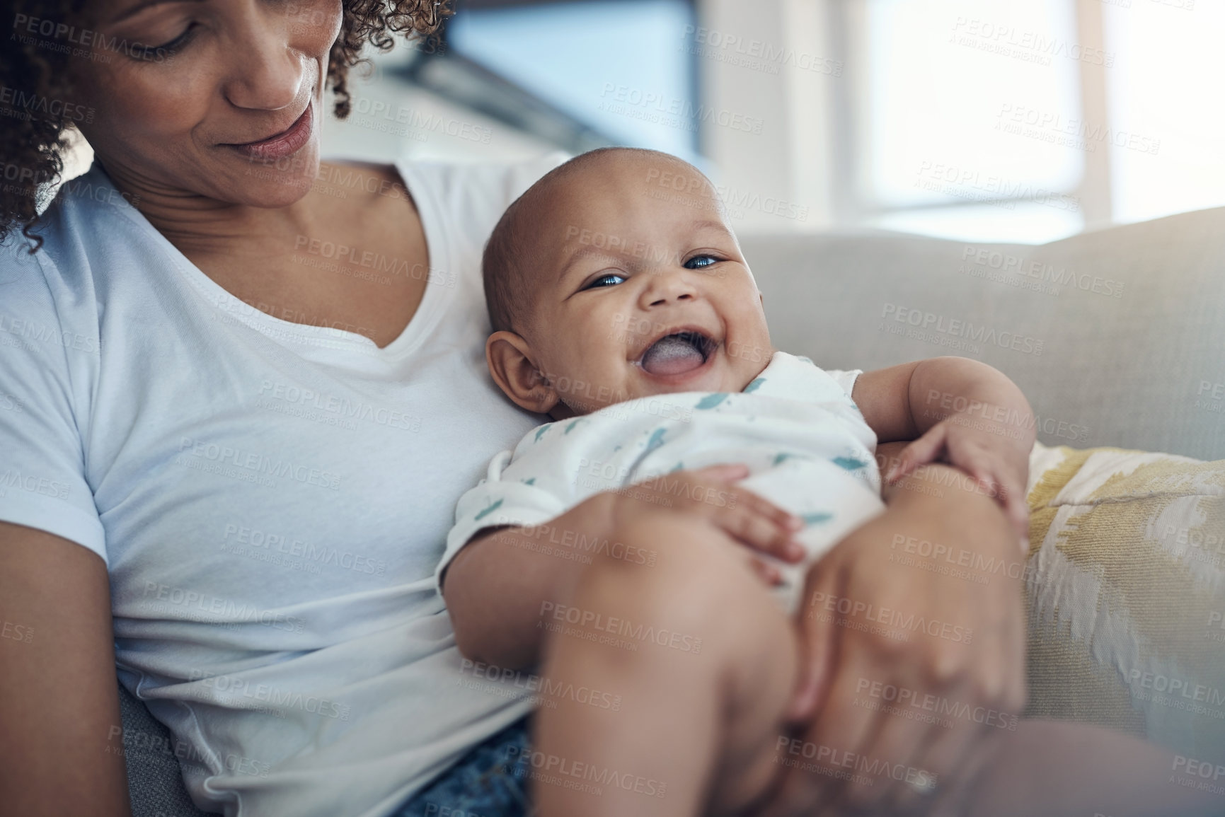 Buy stock photo Shot of a young woman relaxing with her adorable baby girl on the sofa at home