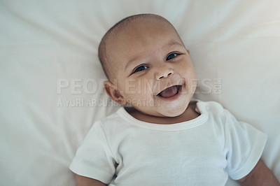 Buy stock photo High angle shot of an adorable baby girl on the bed at home