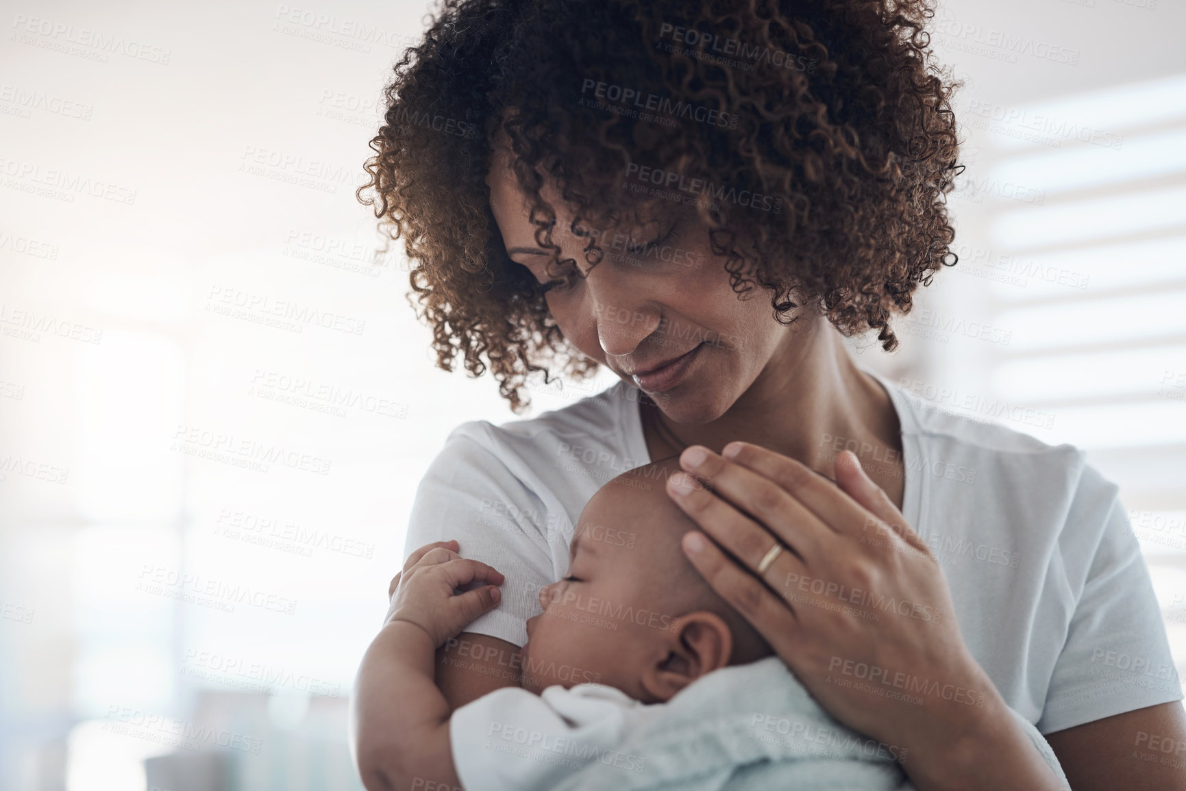 Buy stock photo Shot of an adorable baby girl sleeping peacefully in her mother’s arms at home