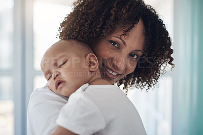 Buy stock photo Shot of an adorable baby girl sleeping peacefully in her mother’s arms at home