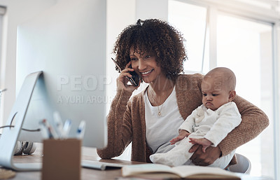 Buy stock photo Shot of a young woman using a smartphone and computer while caring for her adorable baby girl at home