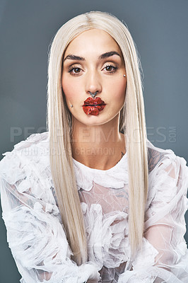 Buy stock photo Portrait of an attractive young woman with bright dramatic red lips against a grey background