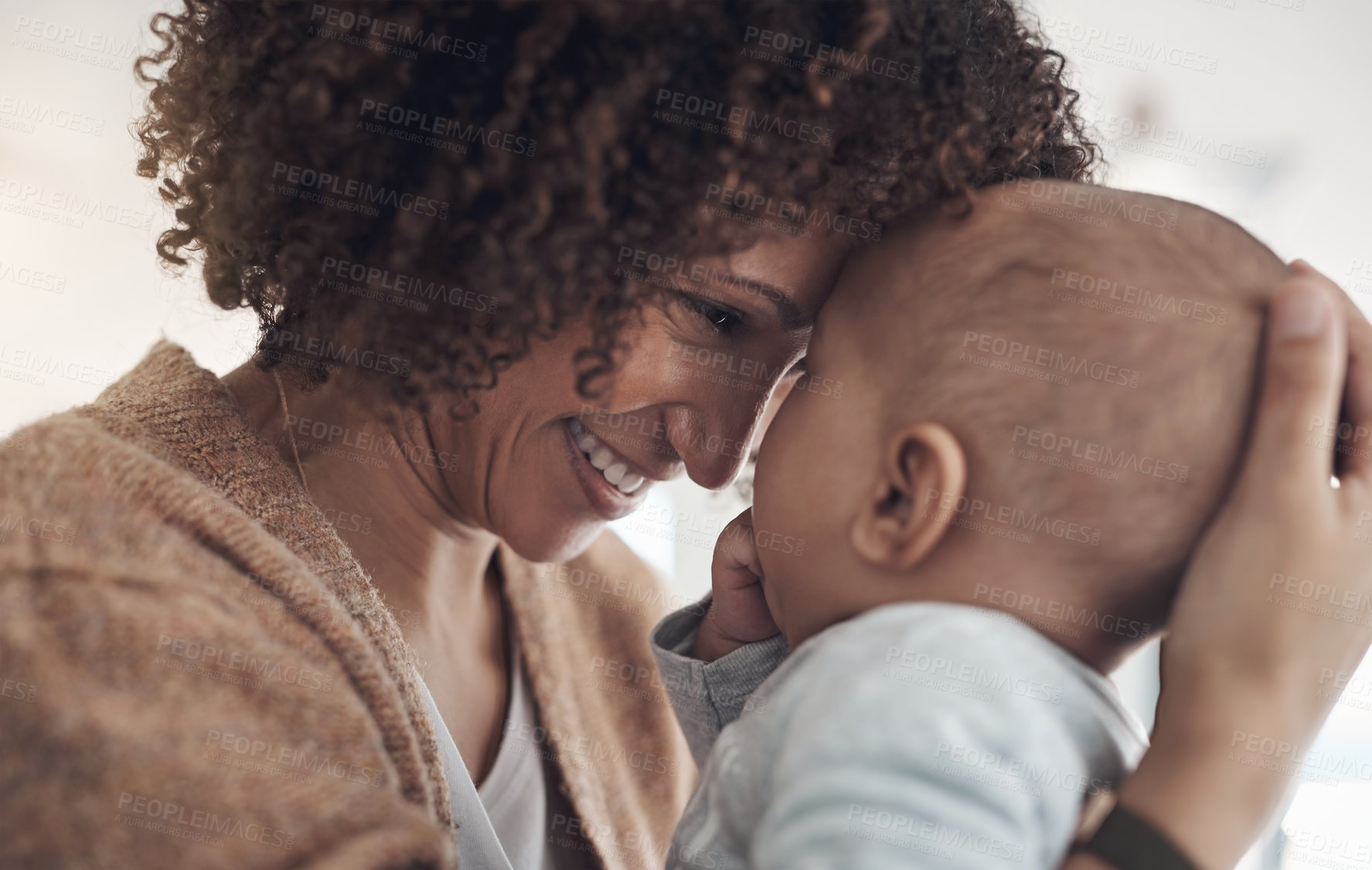 Buy stock photo Shot of a young woman carrying her adorable baby girl at home