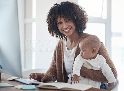 Buy stock photo Shot of a young woman using a computer while caring for her adorable baby girl at home