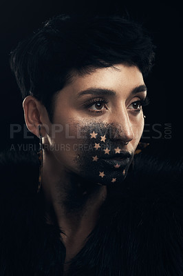 Buy stock photo Studio shot of a young woman posing with paint on her face on a grey background