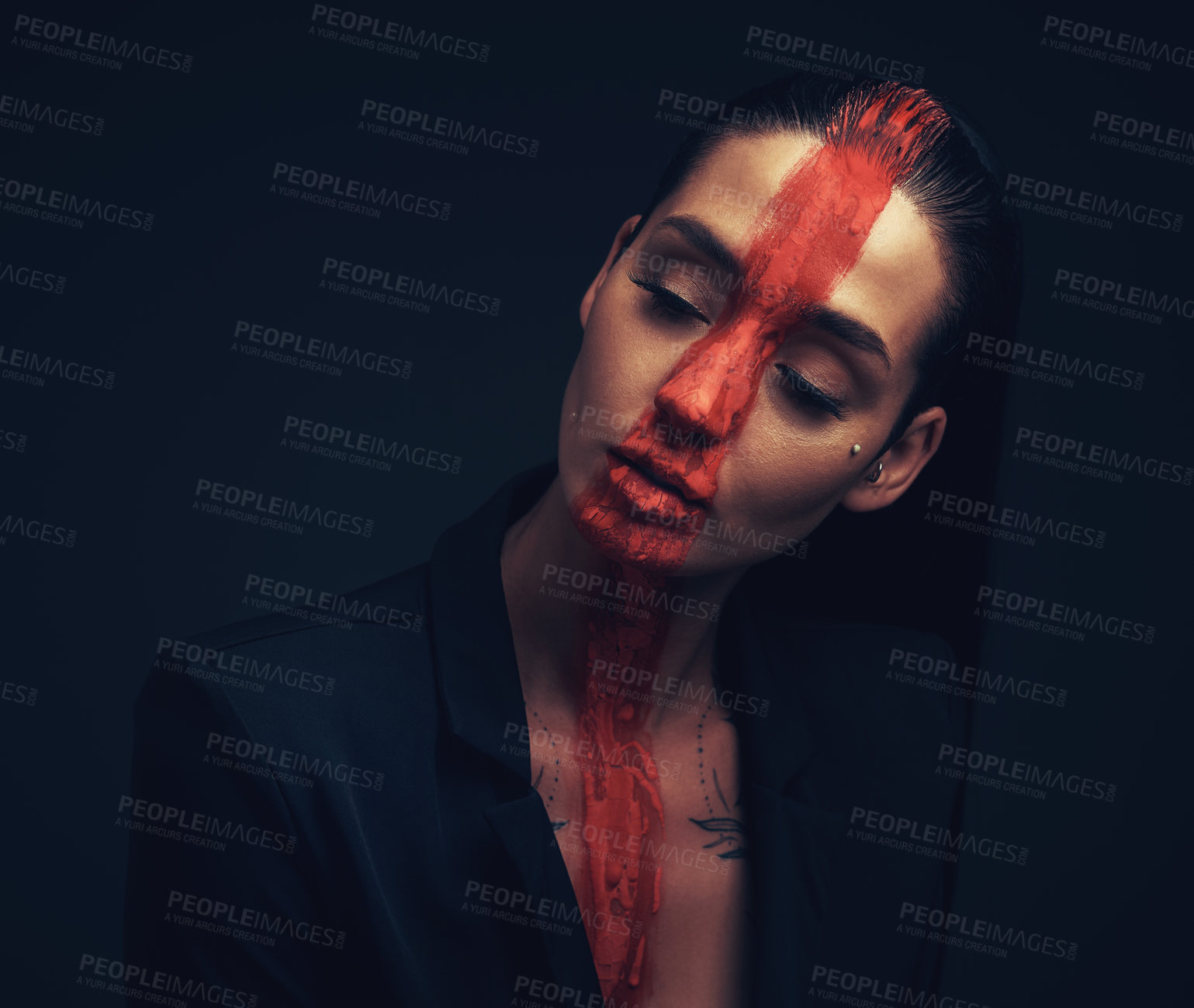 Buy stock photo Studio shot of a young woman posing with paint on her face on a black background