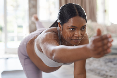 Buy stock photo Shot of a beautiful young pregnant woman doing yoga at home