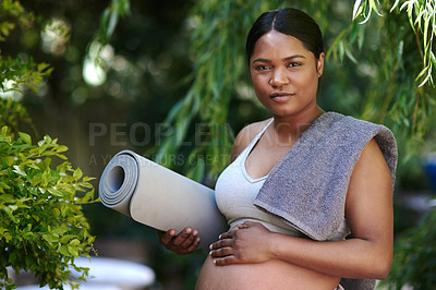 Buy stock photo Shot of a beautiful young pregnant woman standing outside with her yoga mat